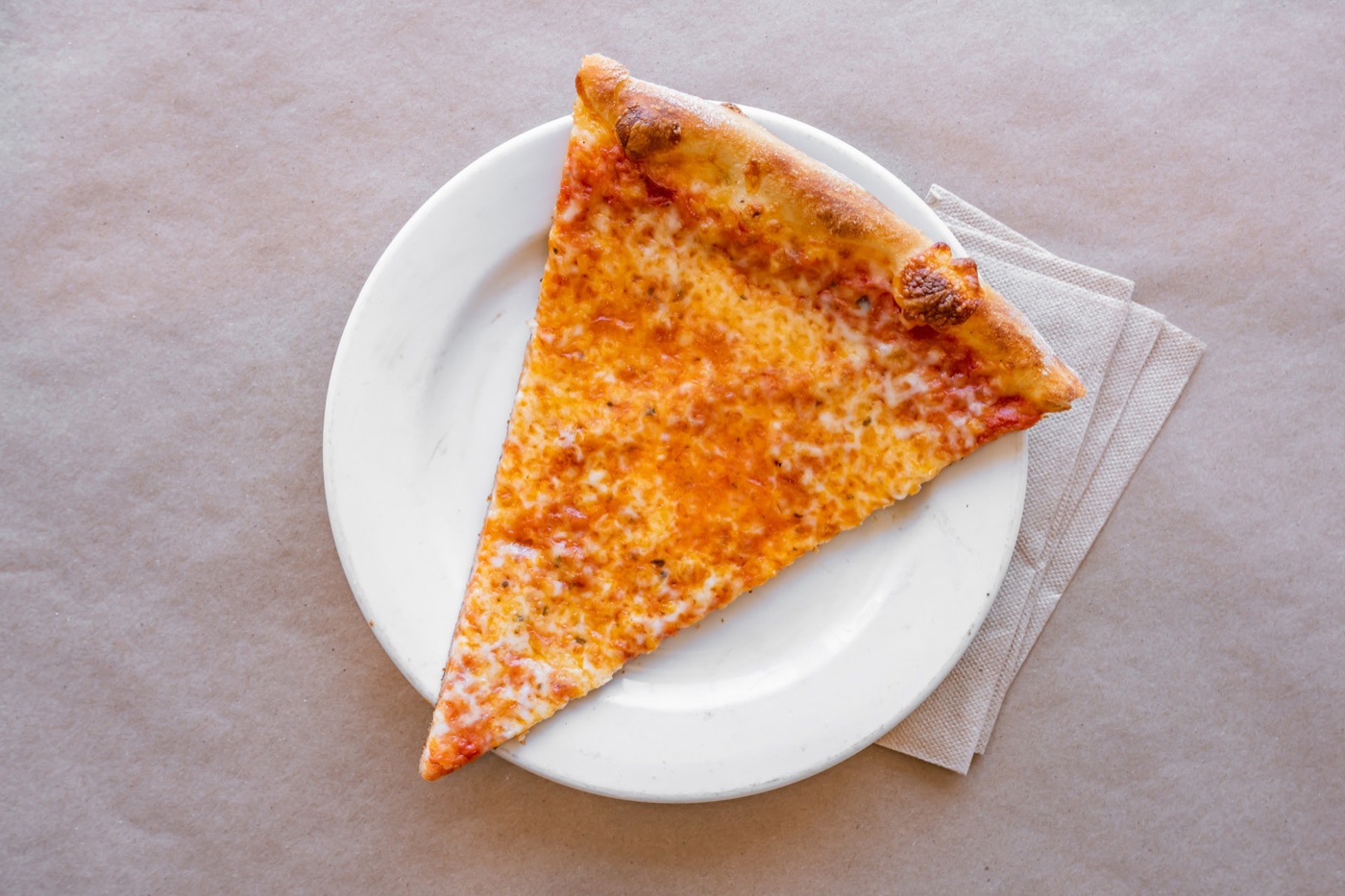 Classic New York cheese slice from Gigi's on a white plate