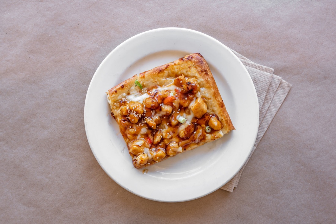 General Tso's chicken pizza slice from Gigi's