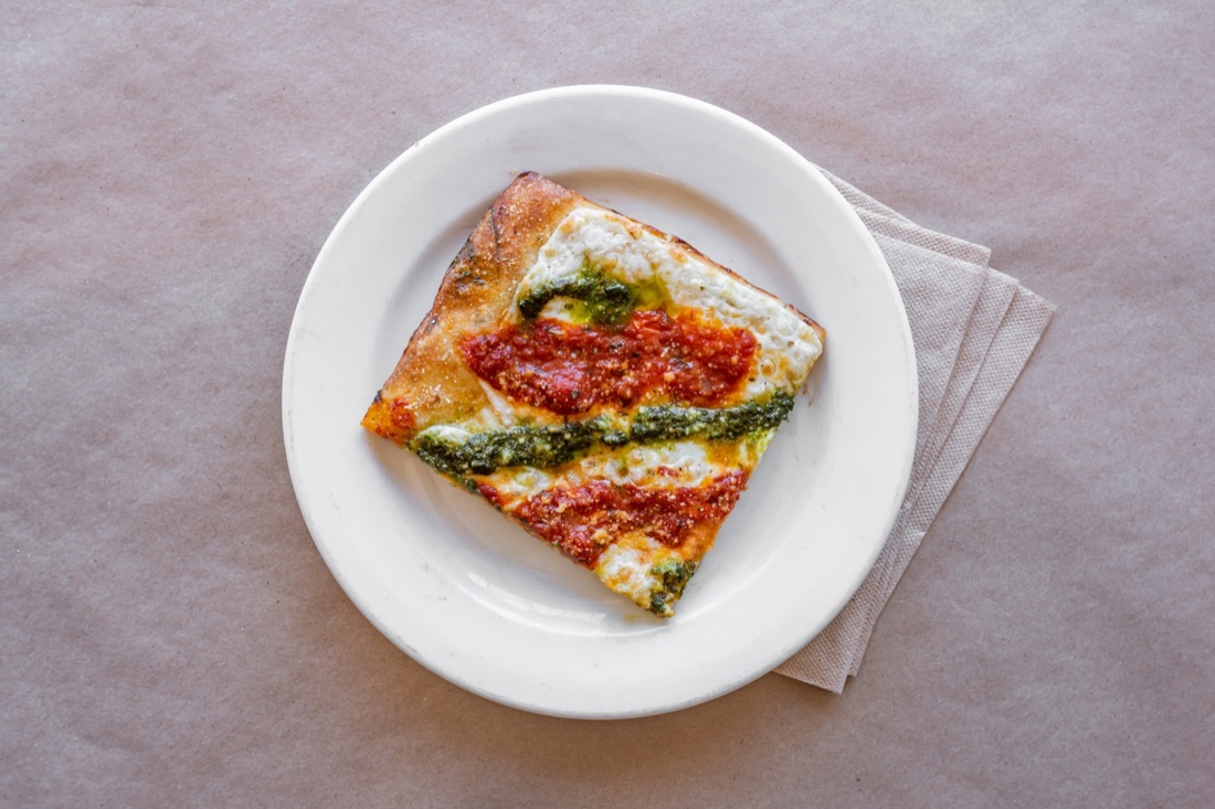 Grandma pie square slice with marinara and pesto from Gigi's